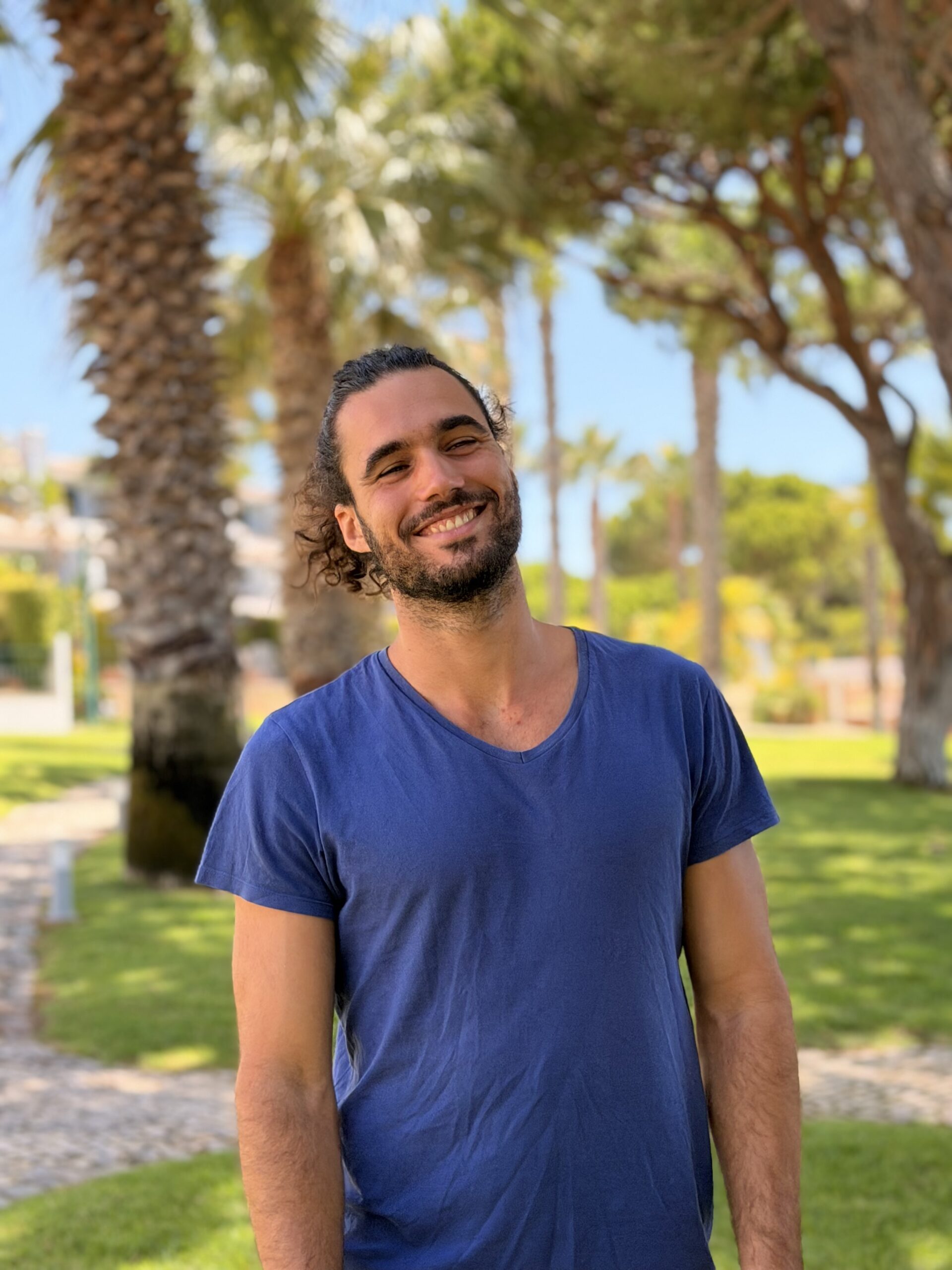 Befriend Your Emotions Dr. Filipe Rocha smiling outdoors, among palm trees